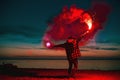 Man goes with torch fire at sunset beach Royalty Free Stock Photo