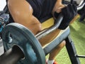 A Man with torn biceps does preacher curls. Working out and injury rehabilitation after 6 months of an untreated grade 3 full