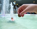 A man tosses a coin into a fountain Royalty Free Stock Photo