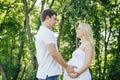 Man touches belly of his pregnant wife during the walk Royalty Free Stock Photo