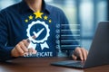 Man touches certificate icon with stars and checklist on a digital screen Royalty Free Stock Photo