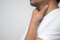 Man touches throat with his hand, sick with influenza