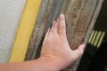 A man touches a wall of the historical object with his hand.