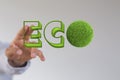 Man touching 3D rendered ECO icons made of grass with his two fingers