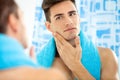 Man touching his face after shaving Royalty Free Stock Photo