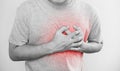 A man touching his heart, with red highlight of heart attack, heart failure, others heart disease and broken heart Royalty Free Stock Photo