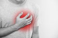 A man touching his heart, with red highlight of heart attack, heart failure and others heart disease