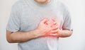 A man touching his heart, with red highlight of heart attack, and others heart disease concept, on white background Royalty Free Stock Photo