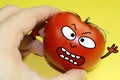 Man touching tomato, and tomato is aggressive, tomato has face, create character with cartoon drawing on cartoonized real photo, r