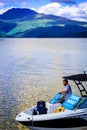 Man on the tour motor boat at the Loch Lomond lake in Scotland, 21 July, 2016 Royalty Free Stock Photo