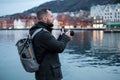 Tourist with camrea against Tyskebryggen in Bergen, Norway