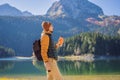 Man tourist in background of Panoramic morning view of Black Lake Crno Jezero. Calm summer scene of Durmitor Nacionalni Royalty Free Stock Photo