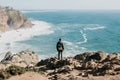 A man tourist with a backpack stands in solitude at Cape Roca in Portugal Royalty Free Stock Photo