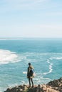 A man tourist with a backpack stands in solitude at Cape Roca in Portugal Royalty Free Stock Photo