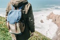 A man tourist with a backpack stands in solitude at Cape Roca in Portugal Royalty Free Stock Photo