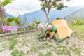 Man tourist backpacker awakening getting out tent camping, Bolivia traveling. Royalty Free Stock Photo