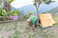 Man tourist backpacker awakening getting out tent camping, Bolivia traveling. Royalty Free Stock Photo