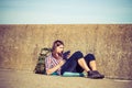 Man tourist backpacker sitting with tablet outdoor Royalty Free Stock Photo