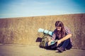 Man tourist backpacker sitting with tablet outdoor Royalty Free Stock Photo