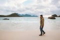 Man tourist enjoying ocean view walking on sandy Haukland beach traveling in Norway Royalty Free Stock Photo