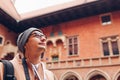 Man tourist enjoys excursion in Medieval Jagiellonian University Collegium Maius Krakow Poland using audio tour guide