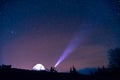 Tourist with flashlight near his camp tent under a sky full of stars, night mountain loneliness Royalty Free Stock Photo