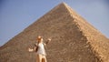 Man tourist with hat and bag walks background of pyramids in Giza Cairo Egypt, sun light travel Royalty Free Stock Photo