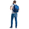 A man tourist in jeans with blue backpack standing looking