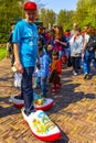 Man tourist with large wooden Dutch clogs shoes Netherlands Royalty Free Stock Photo