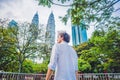 Man tourist in Malaysia looks at the Petronas Twin Towers Royalty Free Stock Photo