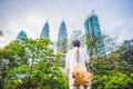 Man tourist in Malaysia looks at the Petronas Twin Towers Royalty Free Stock Photo