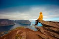 Man tourist sitting on edge of a rock