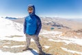 Man tourist standing mountain summit, Cordillera range, Bolivia.