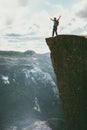 Man tourist success raised hands on Preikestolen cliff