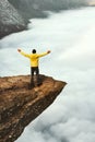 Man tourist success raised hands on Trolltunga rocky cliff edge in Norway Royalty Free Stock Photo