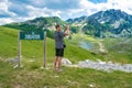 Man tourist near sign with the inscription Durmitor on background mountains Durmitor National Park. Montenegro