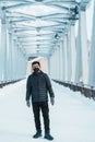 man tourist Visiting in Biei, Traveler in Sweater sightseeing Shirahige Waterfall bridge with Snow in winter. landmark and popular