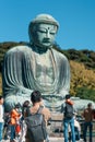 man tourist Visiting in Kamakura, Kanagawa, Japan. happy Traveler sightseeing the Great Buddha statue. Landmark and popular for Royalty Free Stock Photo