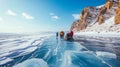 Man tourist walking on the ice of Baikal lake. Winter landscape of lake. Blue transparent cracked ice and the blue sky. Royalty Free Stock Photo