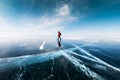 Man tourist walking on the ice of Baikal lake. Winter landscape of Baikal lake, Russia Royalty Free Stock Photo