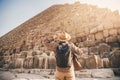 Man tourist walks background of pyramids in Giza Cairo Egypt, sun light Royalty Free Stock Photo