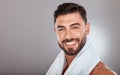Man with towel, beauty and face with skincare, hygiene and self care portrait against studio background. Grooming, skin