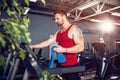 Man with a towel beside a treadmill Royalty Free Stock Photo