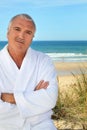 Man in a toweling robe by the sea Royalty Free Stock Photo