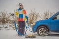 Man with towing rope hooks near towed car Royalty Free Stock Photo