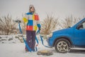 Man with towing rope hooks near towed car Royalty Free Stock Photo