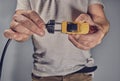 Man with toy car and electricity plug Royalty Free Stock Photo