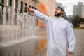 A man in traditional arabian clothing waving his hand Royalty Free Stock Photo