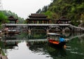 Man in a traditional boat on a chinese river at the afternoon Royalty Free Stock Photo