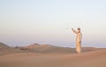 Man in traditional outfit in a desert near Dubai Royalty Free Stock Photo